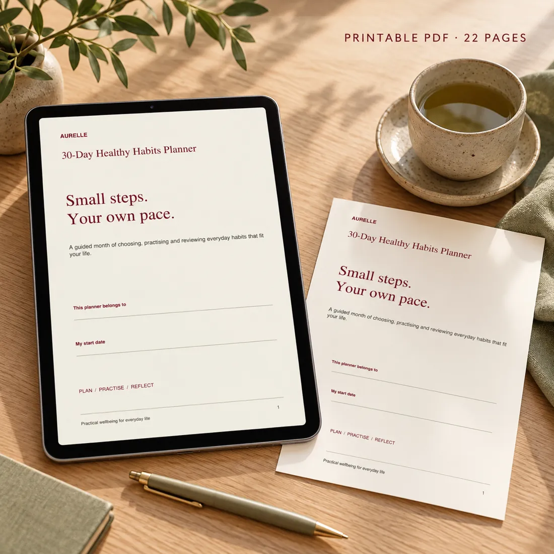 30 day healthy habits planner PDF displayed on a tablet with a printed cover sheet